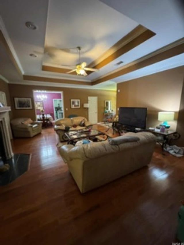 16107 Otter Creek Pkwy, Little Rock, AR 72210 - living area featuring a tray ceiling, crown molding, wood finished floors, and a ceiling fan