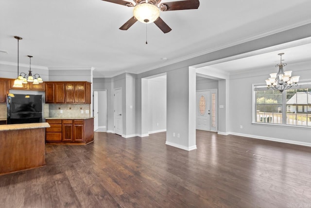 unfurnished living room with a chandelier, ceiling fan, dark wood-style flooring, baseboards, and ornamental molding