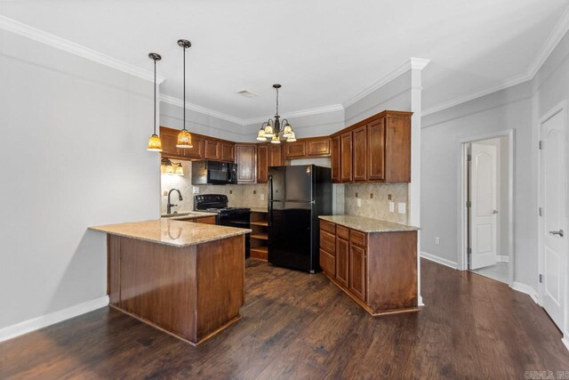 kitchen with black appliances, a peninsula, light stone counters, tasteful backsplash, and crown molding