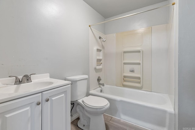 bathroom featuring vanity, toilet, washtub / shower combination, and wood finished floors