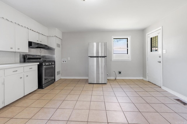 kitchen featuring appliances with stainless steel finishes, light countertops, under cabinet range hood, white cabinets, and light tile patterned floors