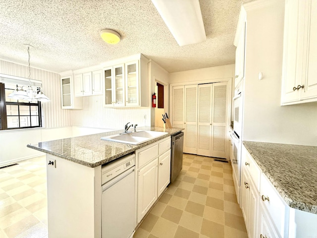 kitchen featuring a sink, light flooring, white appliances, white cabinetry, and glass insert cabinets