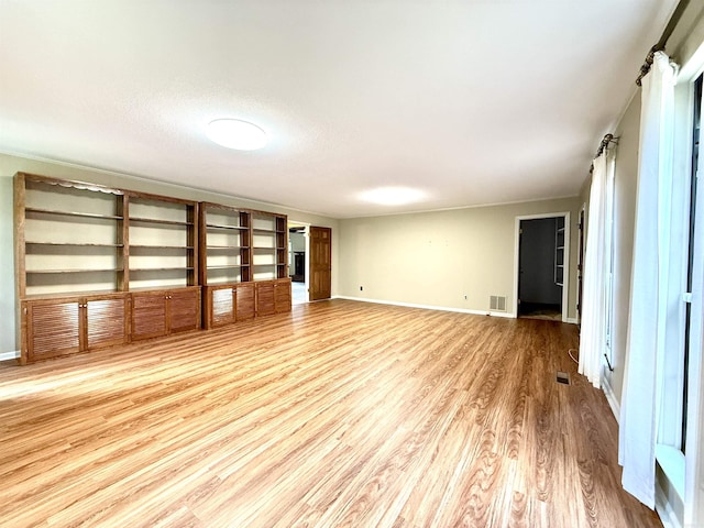 spare room with wood finished floors and baseboards