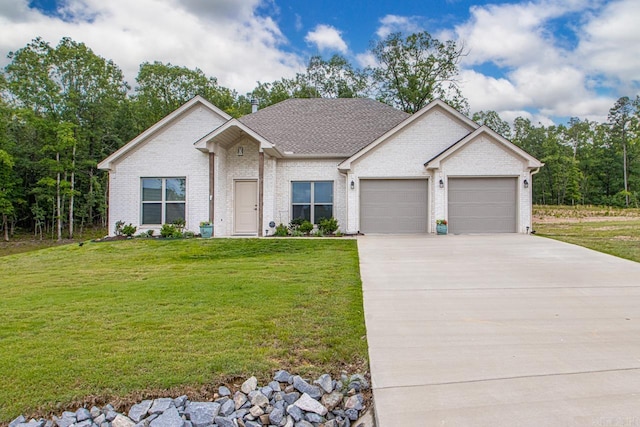 641 Lucy Ln, Alexander, AR 72002 - view of front of house featuring an attached garage, a front yard, concrete driveway, brick siding, and a shingled roof