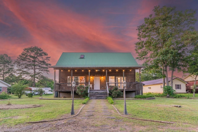 221 Skyline Dr, Greers Ferry, AR 72067 - chalet / cabin with a lawn, covered porch, and metal roof