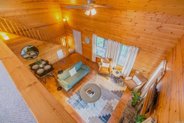 221 Skyline Dr, Greers Ferry, AR 72067 - living area with wooden walls, wood finished floors, ceiling fan, and a high ceiling