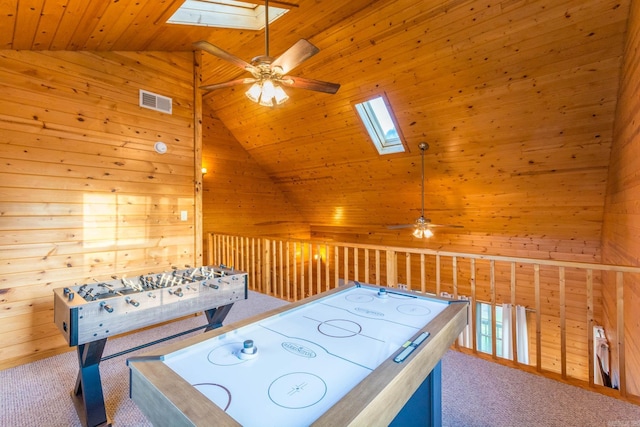 221 Skyline Dr, Greers Ferry, AR 72067 - recreation room with a skylight, ceiling fan, wood walls, wood ceiling, and carpet flooring