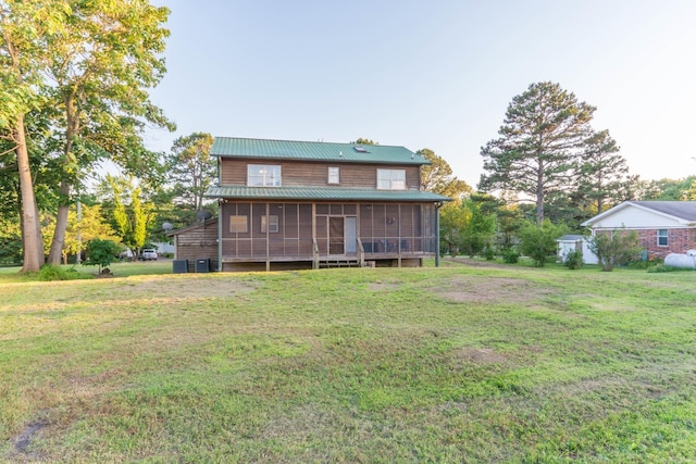 221 Skyline Dr, Greers Ferry, AR 72067 - back of property featuring a sunroom, a yard, metal roof, and cooling unit