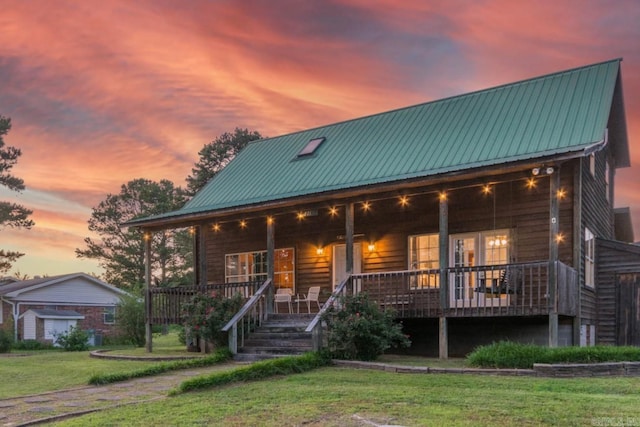 221 Skyline Dr, Greers Ferry, AR 72067 - rustic home featuring a porch, a lawn, and metal roof