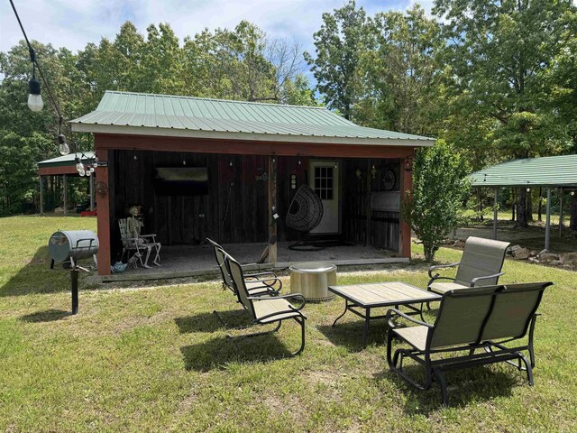 back of house with a yard and metal roof