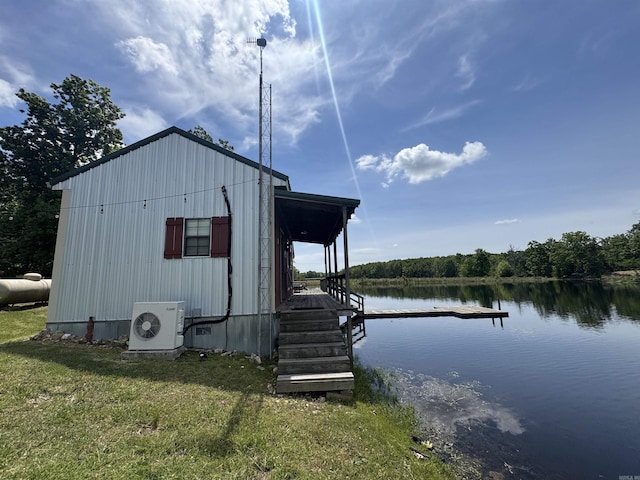 view of outdoor structure with a cooling unit and a water view