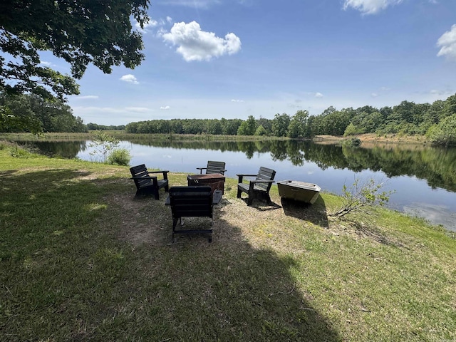 view of yard with a water view and a forest view
