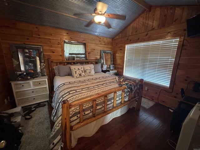 bedroom featuring wood walls, hardwood / wood-style floors, and a ceiling fan