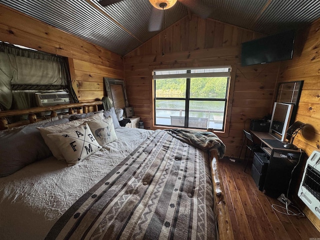 bedroom with wooden walls, wood-type flooring, lofted ceiling, cooling unit, and heating unit