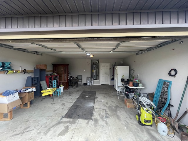 103 Sunflower Ln, Beebe, AR 72012 - garage with freestanding refrigerator, water heater, and a garage door opener