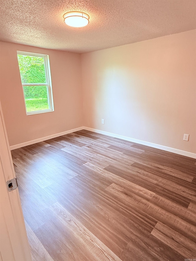 4090 Ar 56th Hwy, Wideman, AR 72585 - spare room with wood finished floors, a textured ceiling, and baseboards