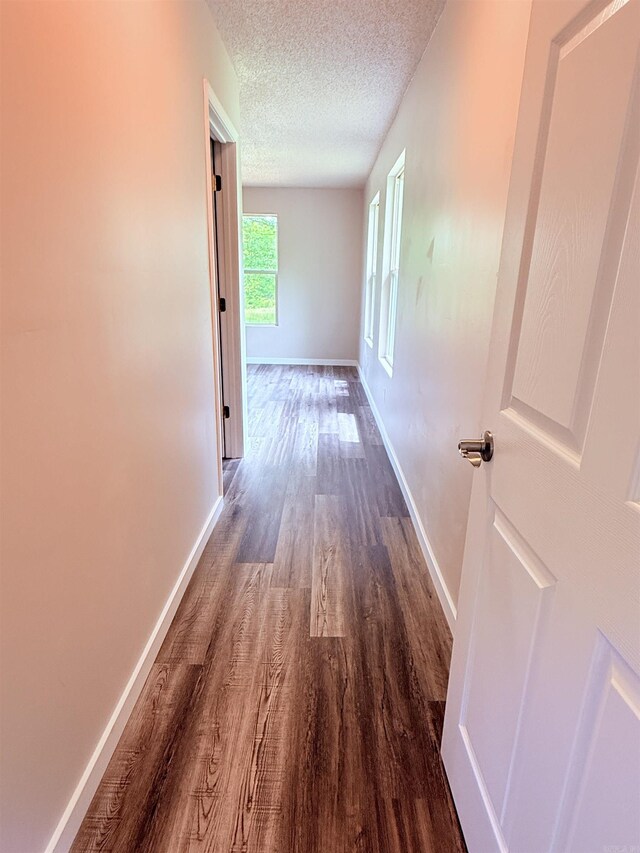 4090 Ar 56th Hwy, Wideman, AR 72585 - corridor with wood finished floors, baseboards, and a textured ceiling