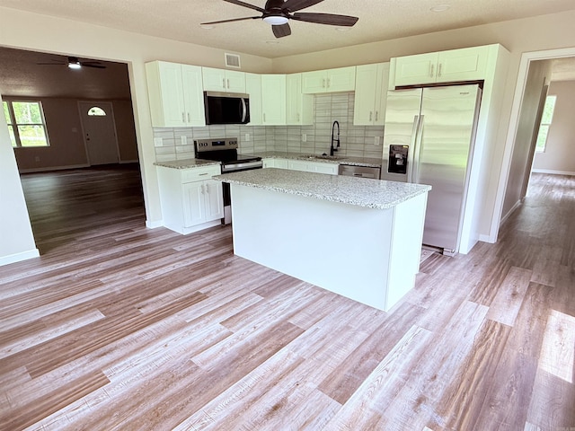 4090 Ar 56th Hwy, Wideman, AR 72585 - kitchen with appliances with stainless steel finishes, ceiling fan, a sink, tasteful backsplash, and healthy amount of natural light
