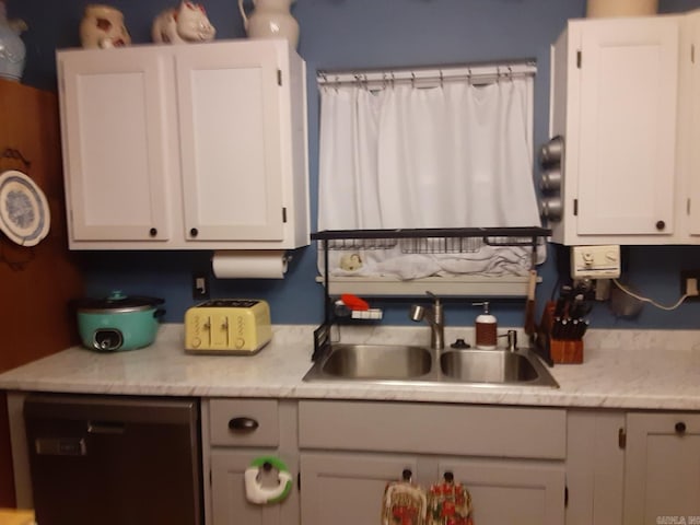 49 Tram, Perryville, AR 72126 - kitchen featuring a sink, dishwashing machine, light countertops, and white cabinetry