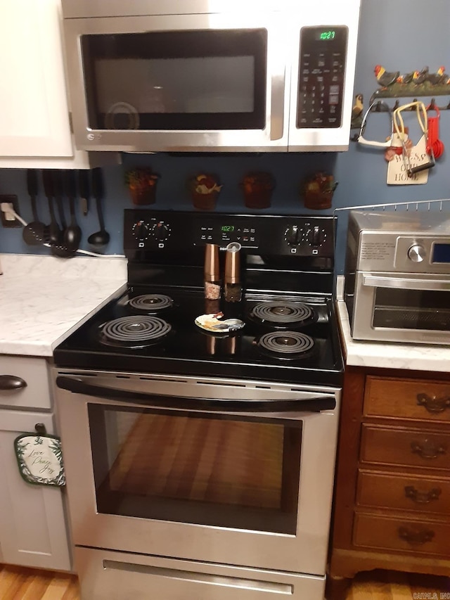 49 Tram, Perryville, AR 72126 - kitchen with appliances with stainless steel finishes, light countertops, and brown cabinets