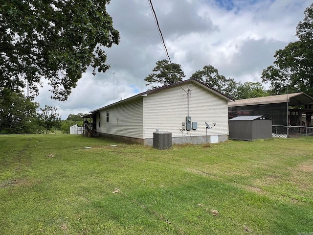 49 Tram, Perryville, AR 72126 - view of side of home with central air condition unit, a shed, a yard, and an outbuilding
