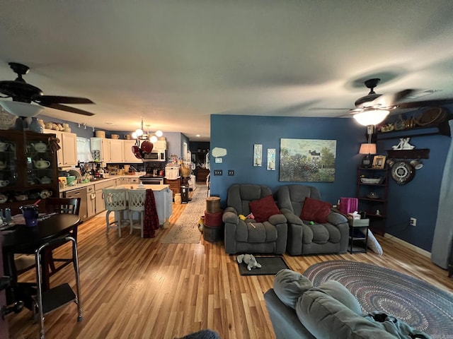 49 Tram, Perryville, AR 72126 - living room featuring a ceiling fan, light wood-type flooring, and a chandelier