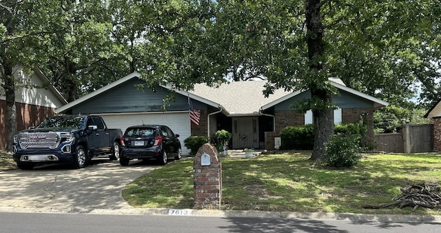 7613 Toltec Dr, North Little Rock, AR 72116 - single story home featuring a garage, concrete driveway, and brick siding