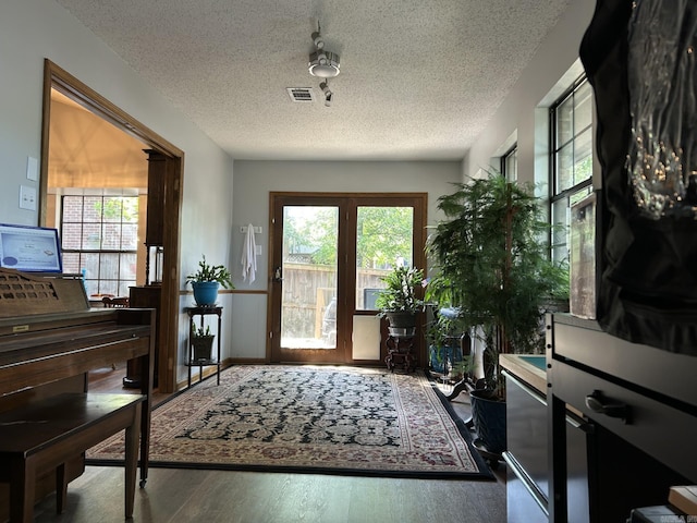 7613 Toltec Dr, North Little Rock, AR 72116 - foyer with wood finished floors, a textured ceiling, and healthy amount of natural light