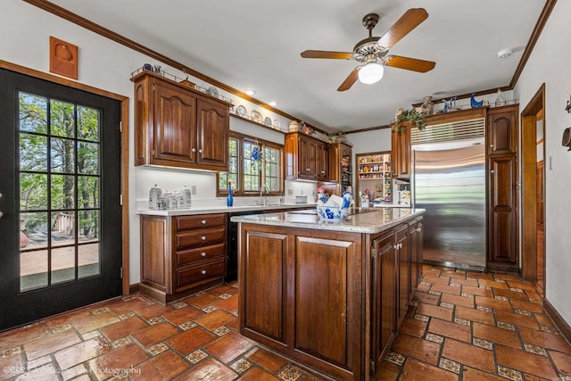 1920 Airpark Rd, Wynne, AR 72396 - kitchen featuring built in refrigerator, ornamental molding, a sink, ceiling fan, and a kitchen island