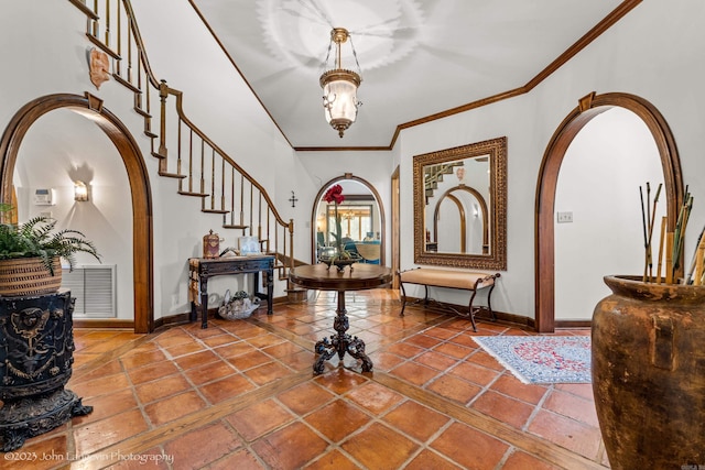 1920 Airpark Rd, Wynne, AR 72396 - foyer with arched walkways, stairs, baseboards, ornamental molding, and tile patterned flooring