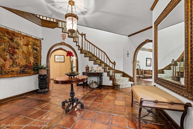 1920 Airpark Rd, Wynne, AR 72396 - entrance foyer featuring arched walkways, stairway, baseboards, and crown molding