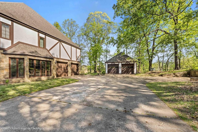 1920 Airpark Rd, Wynne, AR 72396 - view of home's exterior featuring stucco siding, a garage, and an outbuilding