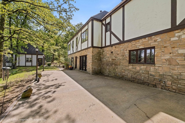 1920 Airpark Rd, Wynne, AR 72396 - view of side of property featuring stone siding, stucco siding, a patio, and an outbuilding
