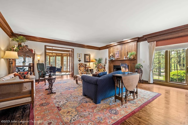 1920 Airpark Rd, Wynne, AR 72396 - living room featuring a fireplace, ornamental molding, plenty of natural light, and wood finished floors