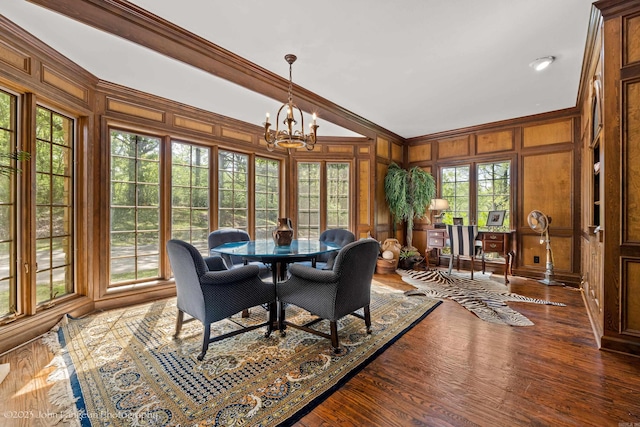 1920 Airpark Rd, Wynne, AR 72396 - dining space with a chandelier, crown molding, plenty of natural light, wooden walls, and wood finished floors