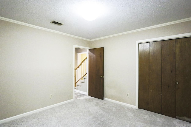 29 Flintwood Dr, Little Rock, AR 72227 - unfurnished bedroom with crown molding, a closet, a textured ceiling, carpet, and baseboards