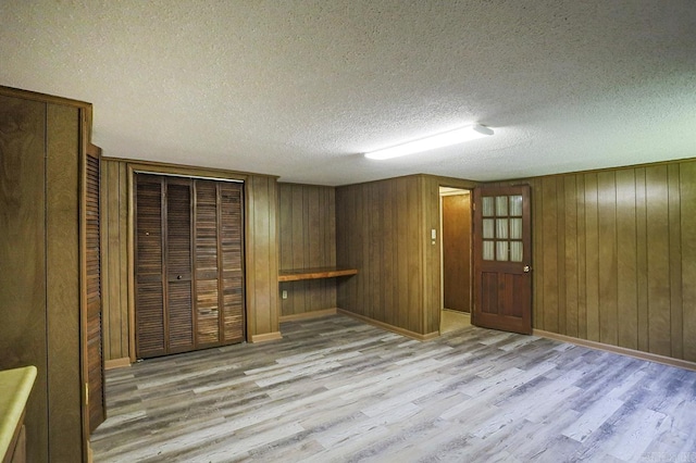 29 Flintwood Dr, Little Rock, AR 72227 - finished below grade area with light wood-type flooring, wooden walls, baseboards, and a textured ceiling