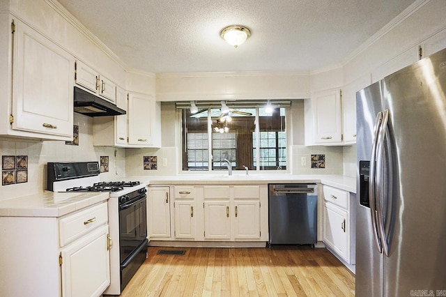 29 Flintwood Dr, Little Rock, AR 72227 - kitchen with appliances with stainless steel finishes, under cabinet range hood, a sink, white cabinetry, and a textured ceiling