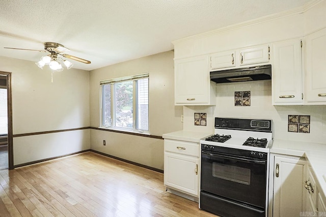 29 Flintwood Dr, Little Rock, AR 72227 - kitchen with gas stove, under cabinet range hood, light countertops, white cabinets, and a textured ceiling