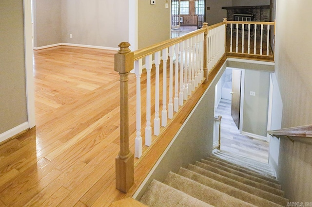 29 Flintwood Dr, Little Rock, AR 72227 - staircase with wood finished floors, baseboards, and a fireplace