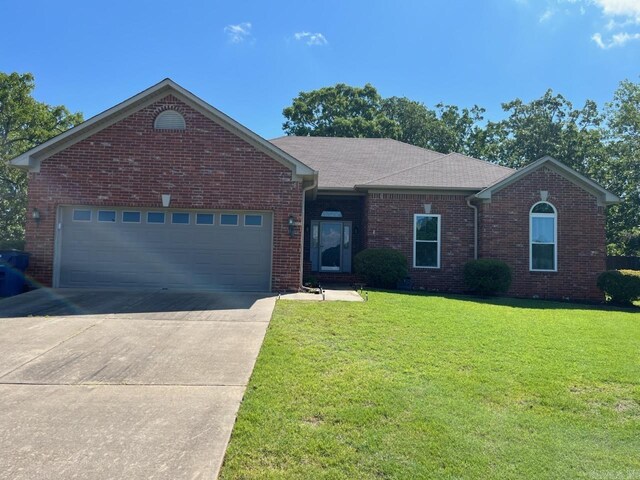 ranch-style house with driveway, a front lawn, brick siding, a garage, and roof with shingles
