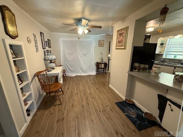 24/82 Whites Cut Rd, Carlisle, AR 72024 - sitting room featuring wood finished floors, a ceiling fan, ornamental molding, and a desk