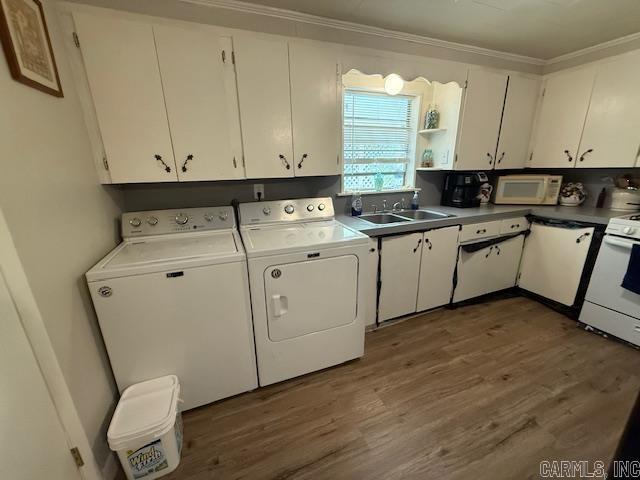 24/82 Whites Cut Rd, Carlisle, AR 72024 - clothes washing area featuring washing machine and clothes dryer, wood finished floors, and ornamental molding