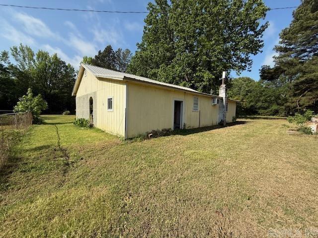 24/82 Whites Cut Rd, Carlisle, AR 72024 - view of property exterior with a lawn and metal roof