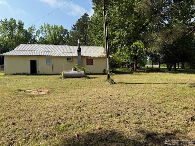 24/82 Whites Cut Rd, Carlisle, AR 72024 - back of property with a yard and metal roof