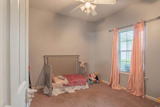 carpeted bedroom featuring a ceiling fan and baseboards