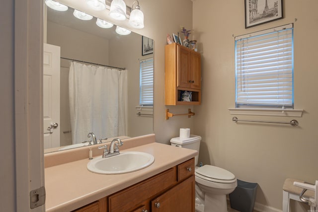 full bath with toilet and vanity