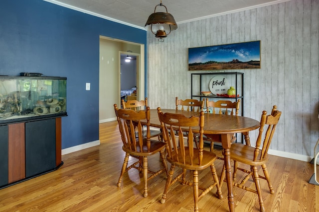 312 N E St, Harrisburg, AR 72432 - dining space with ornamental molding, wood finished floors, baseboards, and wooden walls