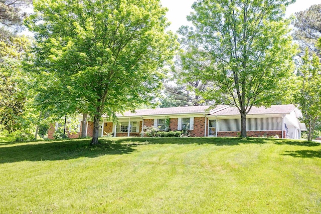 312 N E St, Harrisburg, AR 72432 - ranch-style house featuring a front yard and brick siding