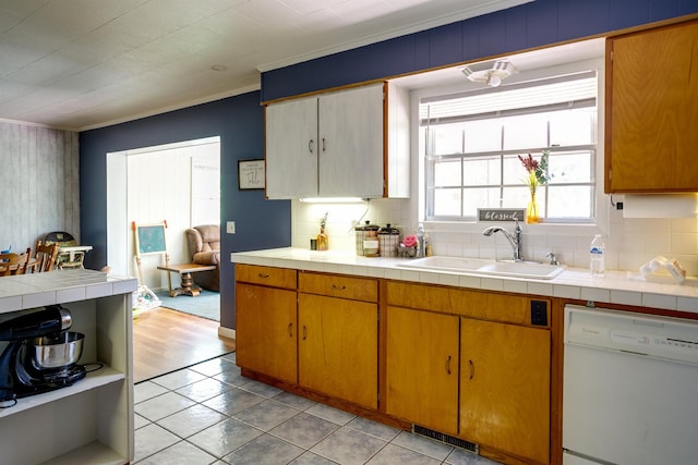 312 N E St, Harrisburg, AR 72432 - kitchen with dishwasher, a sink, backsplash, ornamental molding, and light tile patterned floors